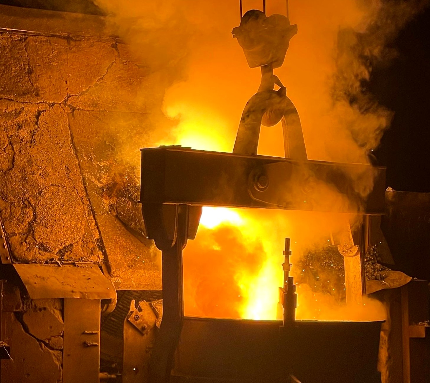 Steel melting shop — crane lifting a glowing ladle